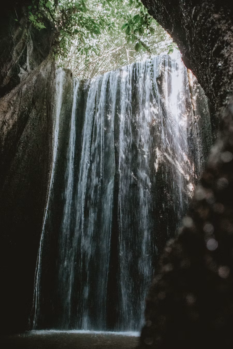 Sunbeams shining through Tukad Cepung Waterfall cave